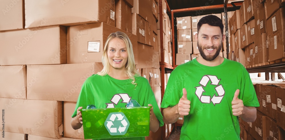 Composite image of portrait of cheerful volunteers in recycling 