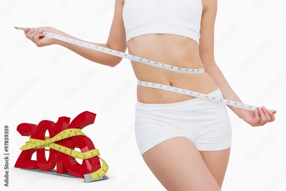 Composite image of slim woman measuring waist with tape measure