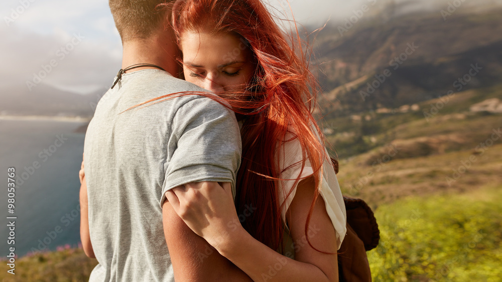 Young couple in love embracing outdoors