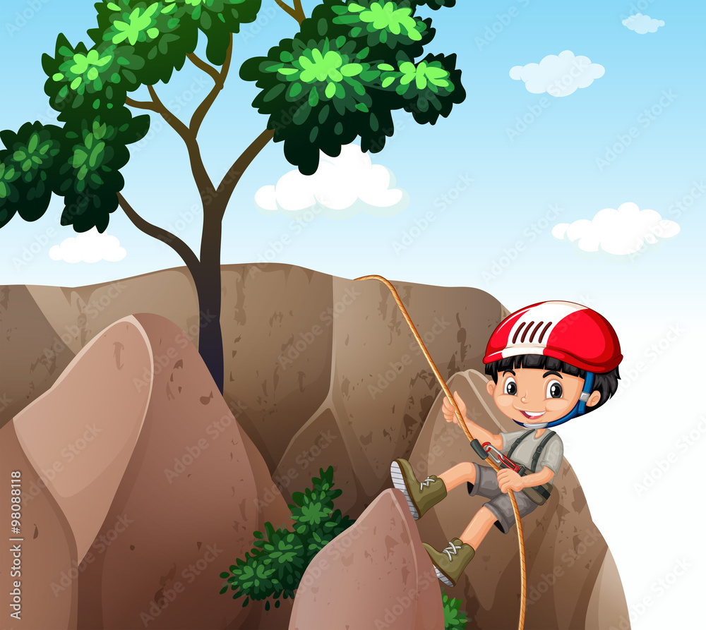 Boy climbing up the cliff