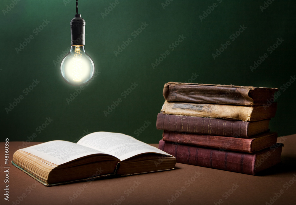 Open book  under the incandescent bulb