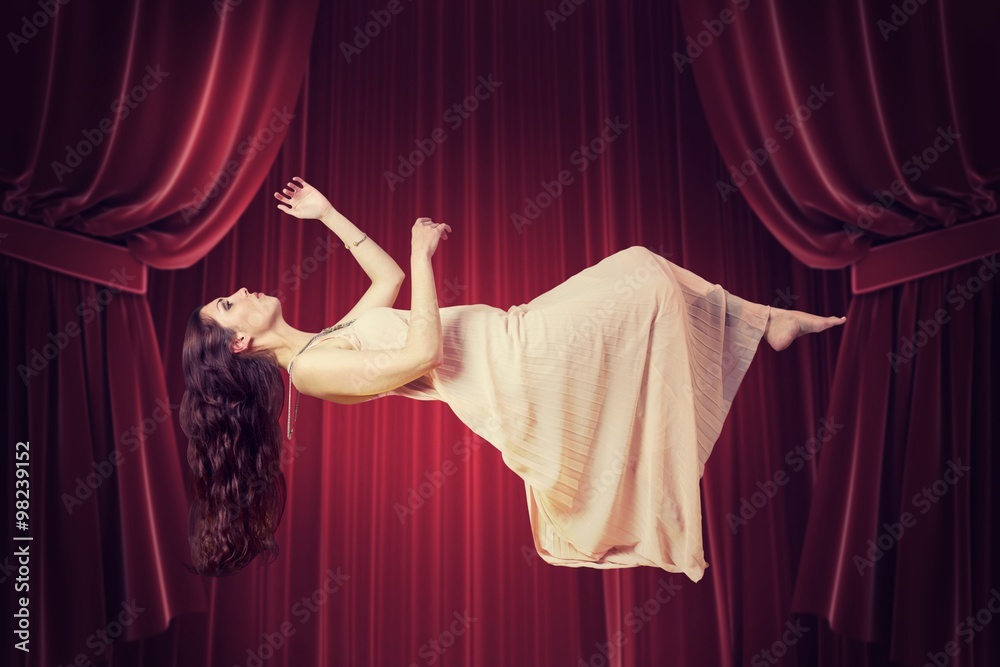 Composite image of full length of beautiful woman flying 