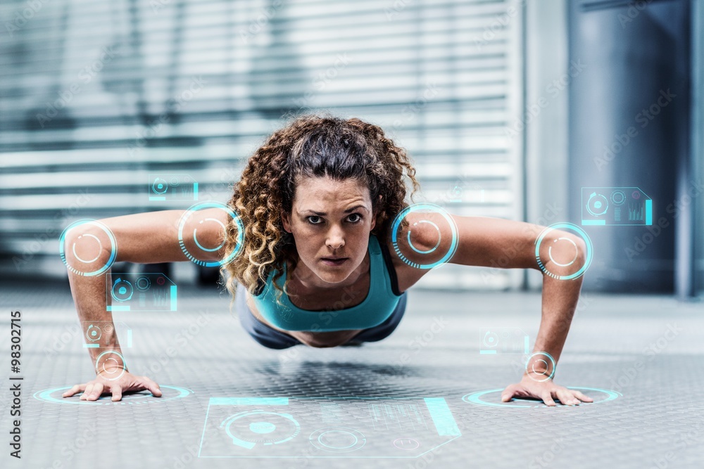 Composite image of attentive muscular woman doing pushups 