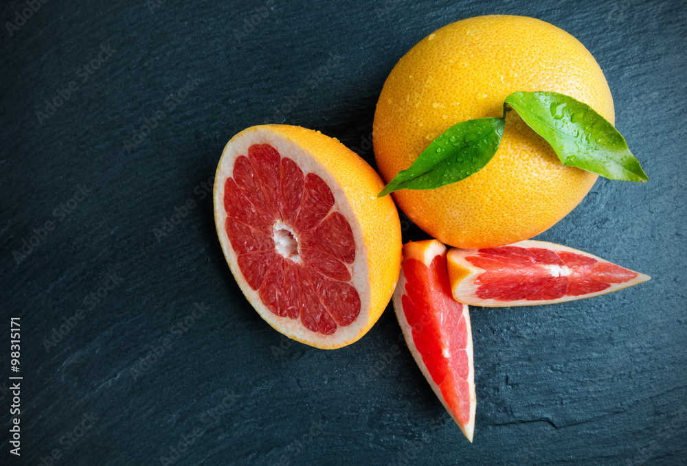 Fresh grapefruit on black stone