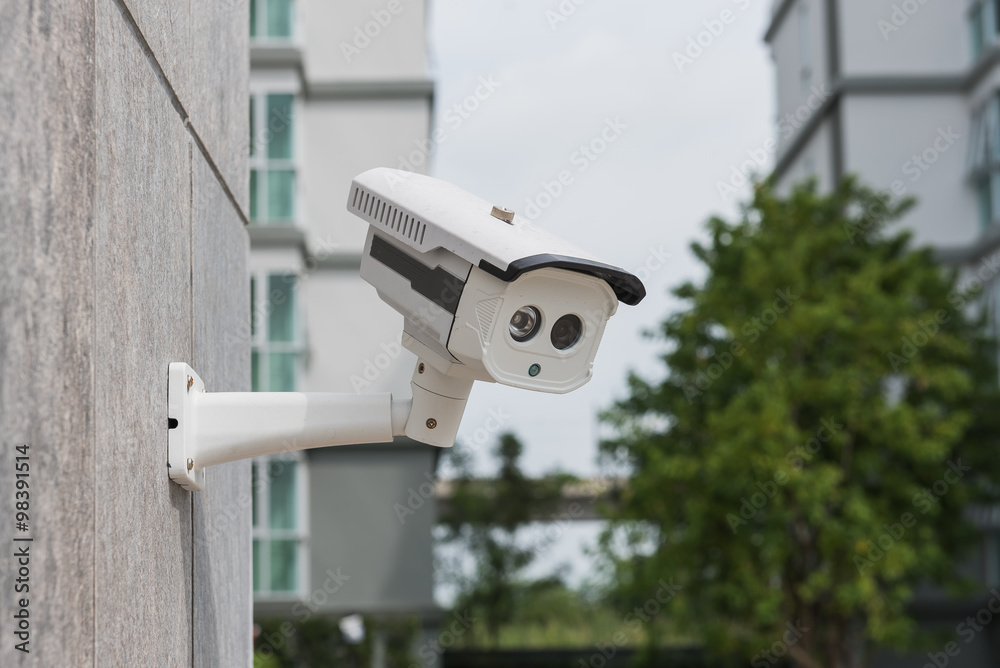 CCTV security camera on stone wall