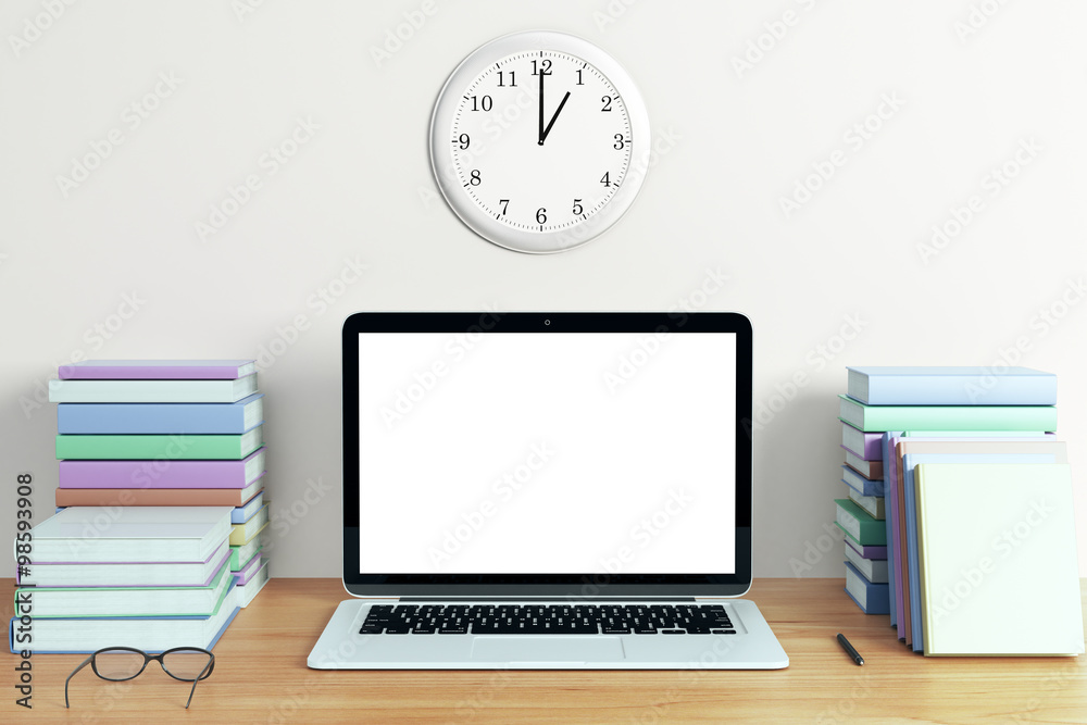 Blank white screen of laptop with piles of books and eyeglasses