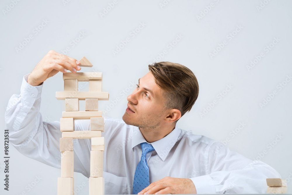 Businessman making tower