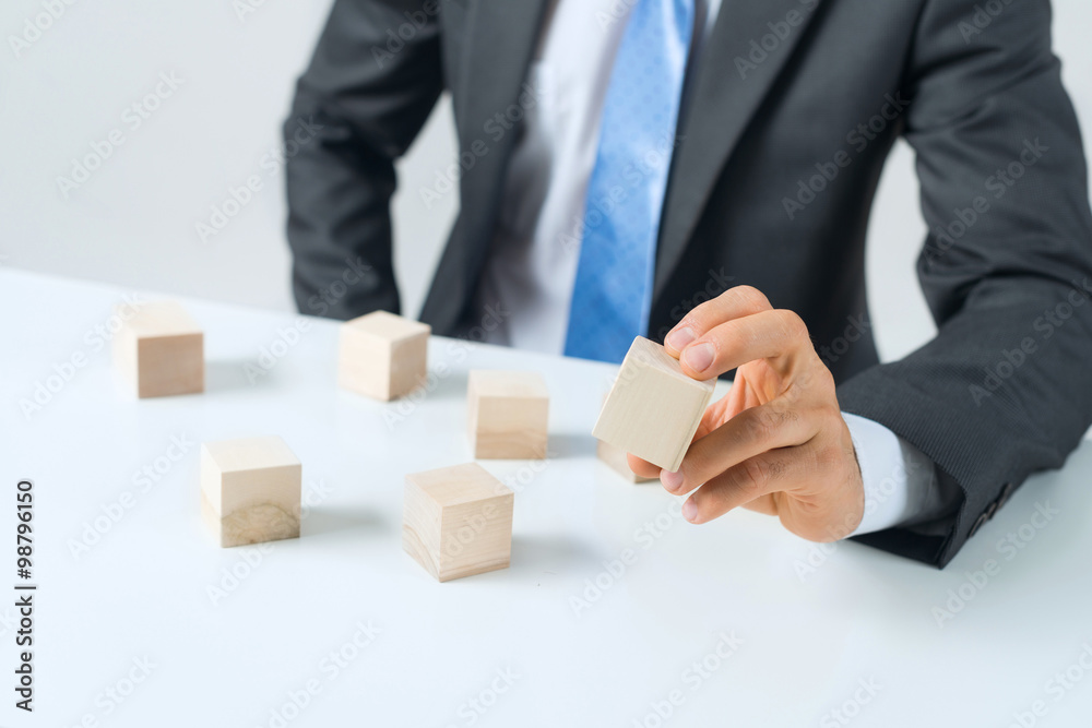 Businessman making tower