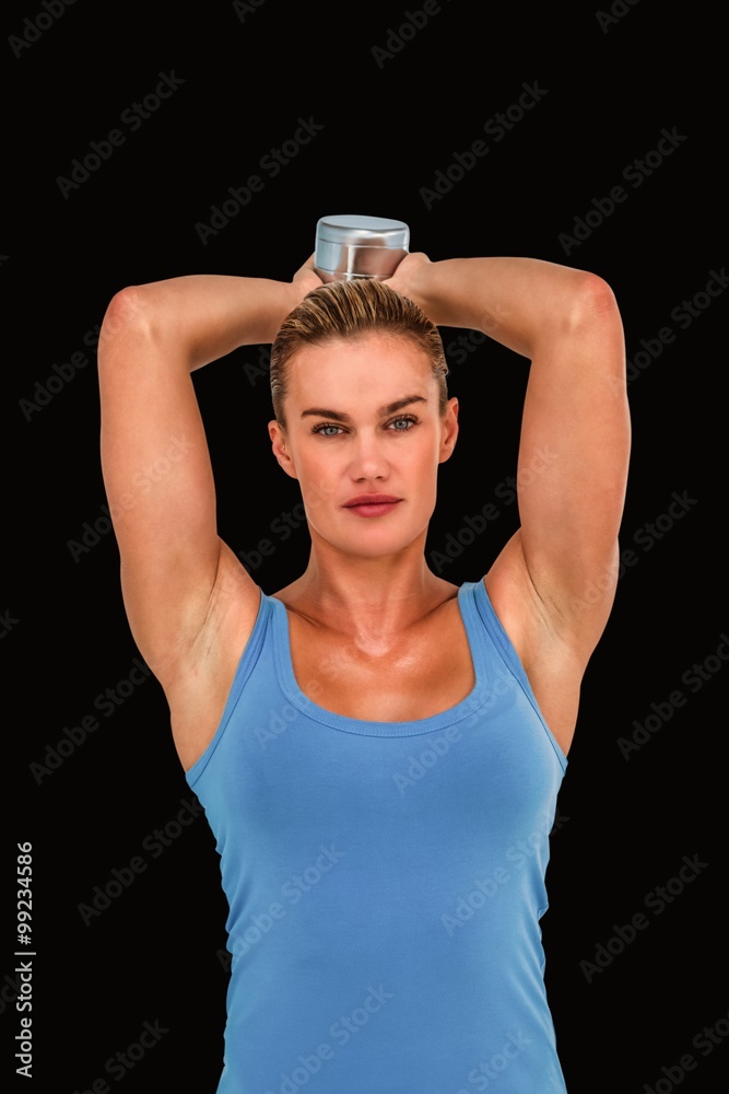 Composite image of muscular woman exercising with dumbbells 