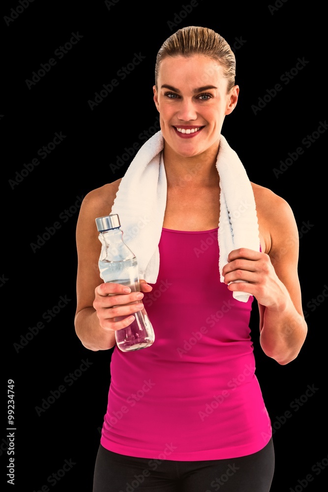 Pretty smiling woman with water bottle and towel