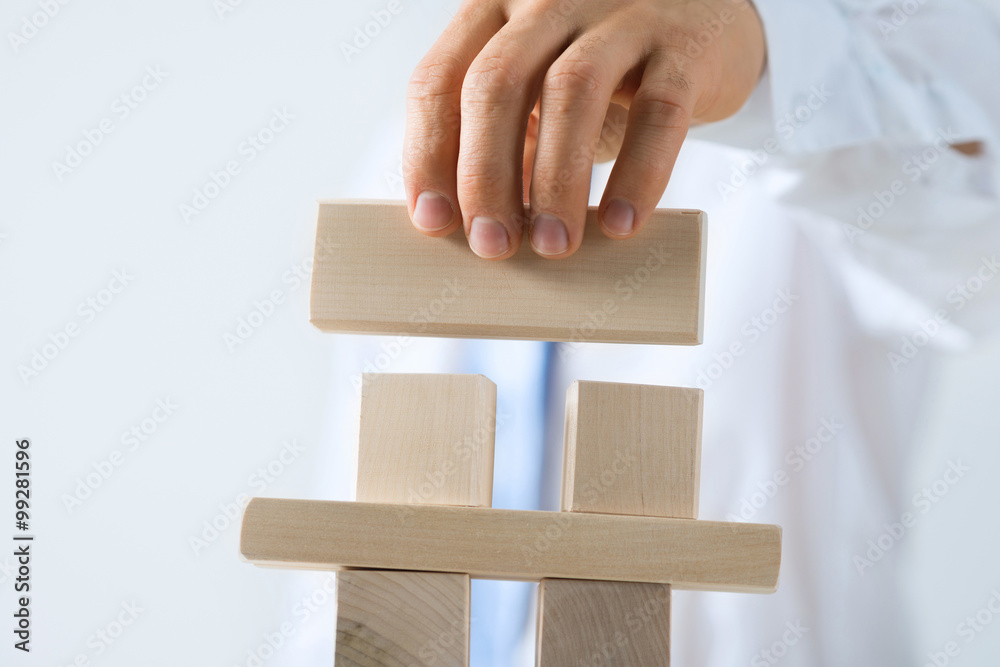 Businessman making tower