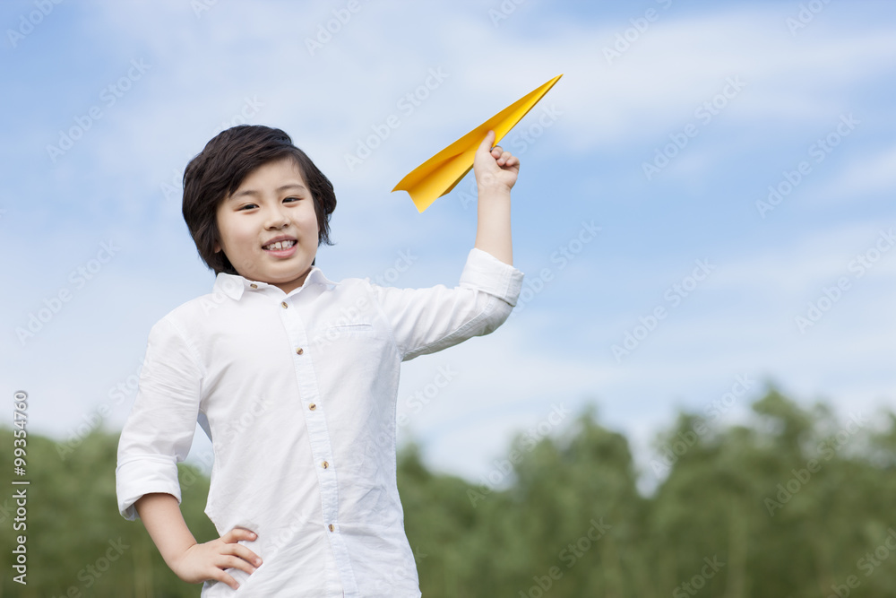 Little boy with paper airplane