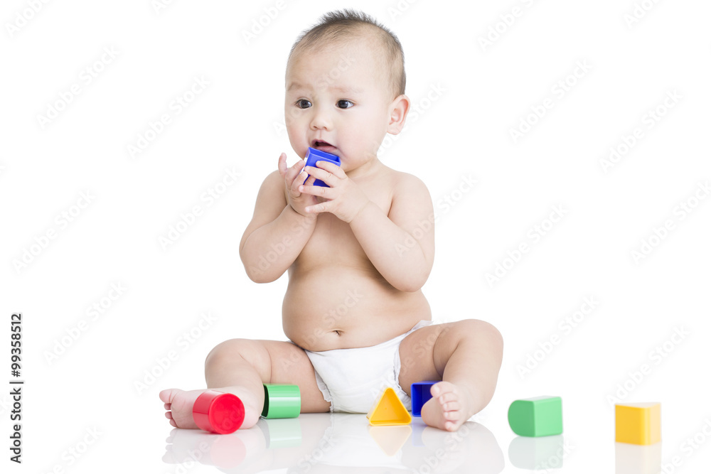 Cute baby boy playing building blocks