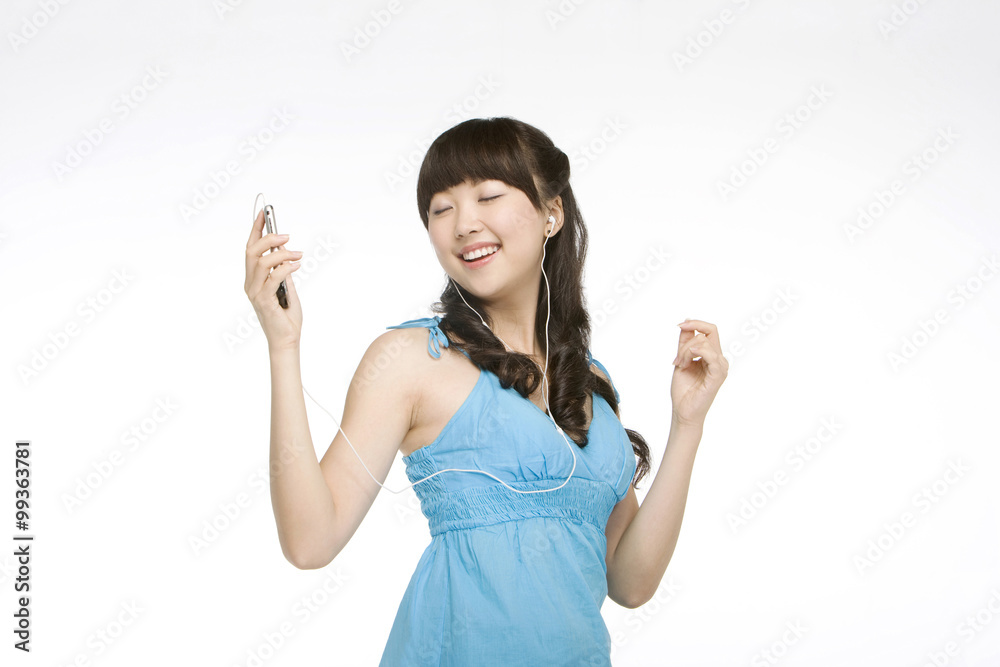 Young woman listening to music on cell phone