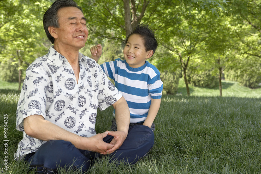 Grandson Annoying Grandfather While He Meditates