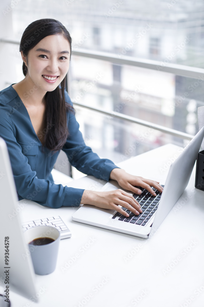 Young businesswoman working in office