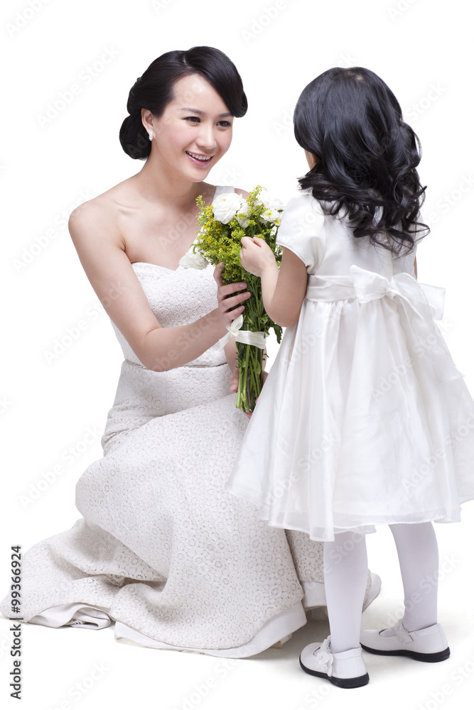 Cute daughter giving flowers to mother