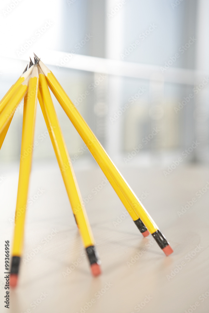 Pencils propped up in a pyramid shape