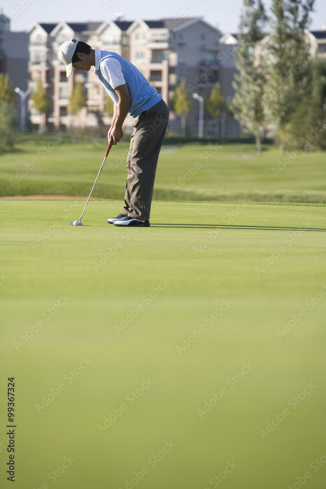 Golfer putting on the Green