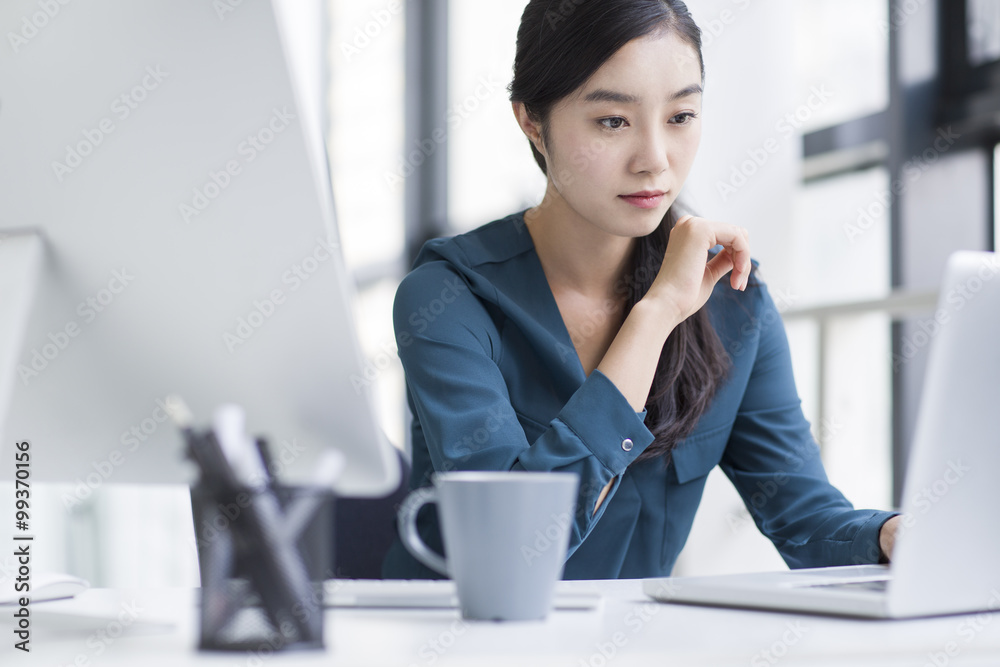 Young businesswoman working in office