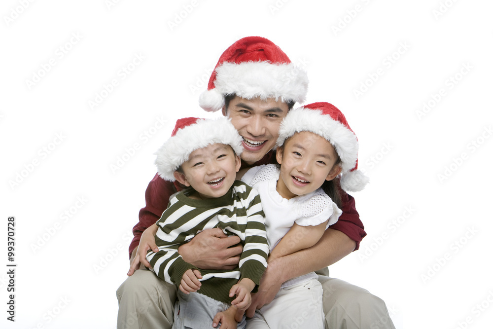 Father and children with Santa hats