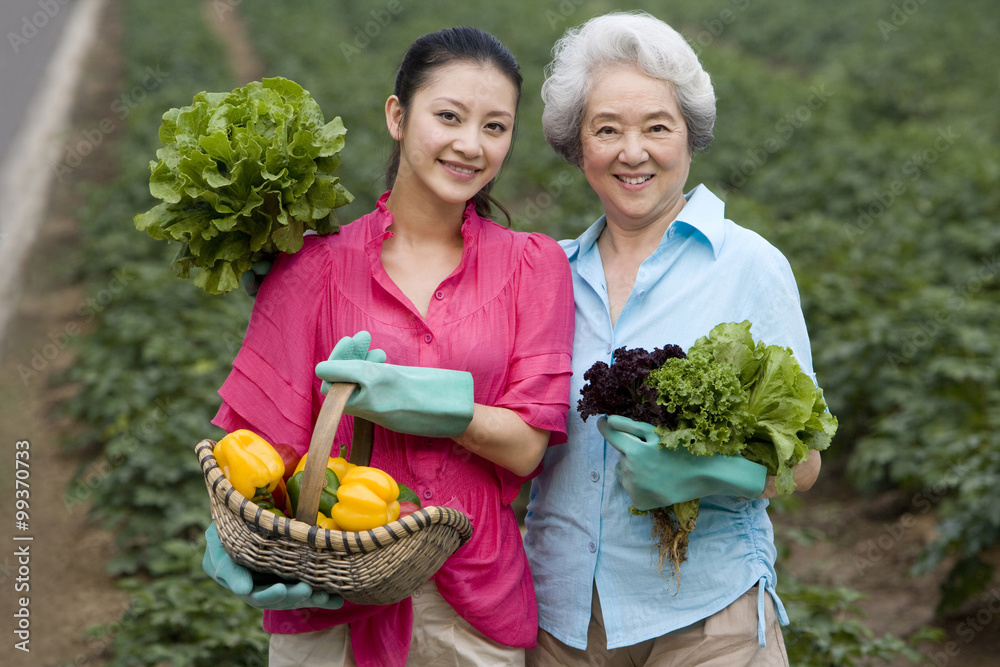 Mother and daughter gardening in farm