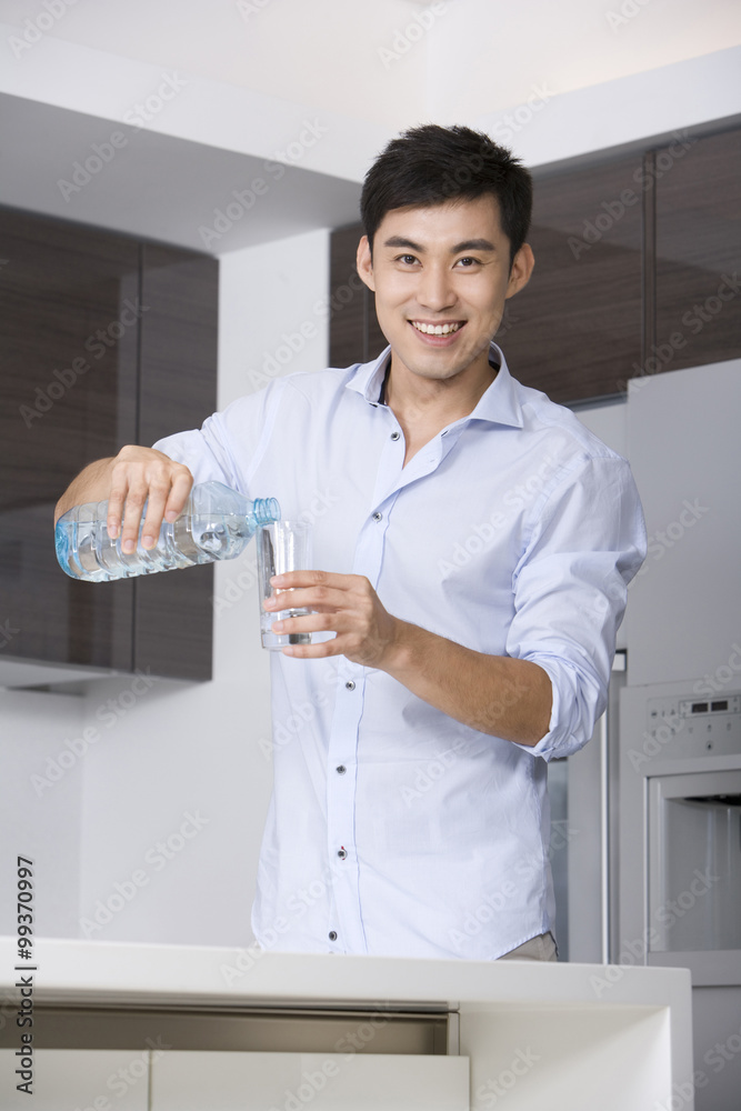 Man pouring a glass of water