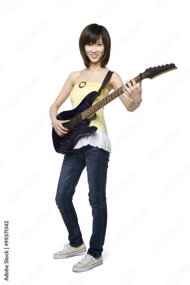 Young woman playing an electric guitar