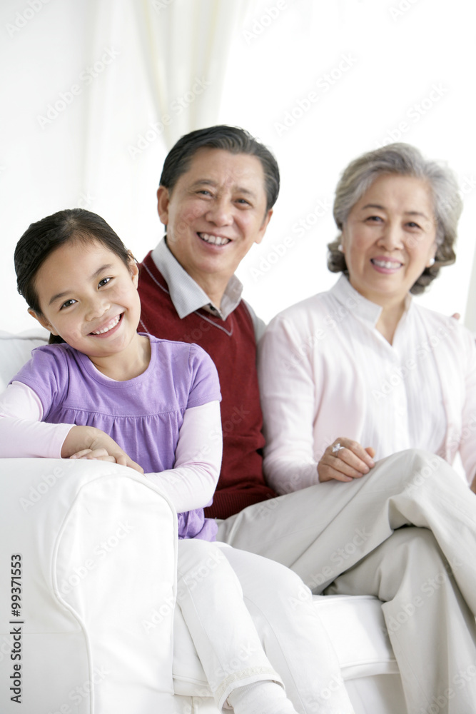 Chinese grandaughter with grandparents in living room