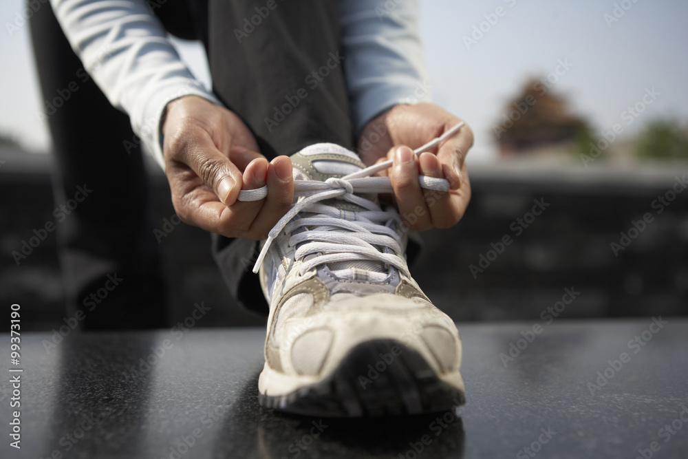 Young Woman Tying Her Shoelaces