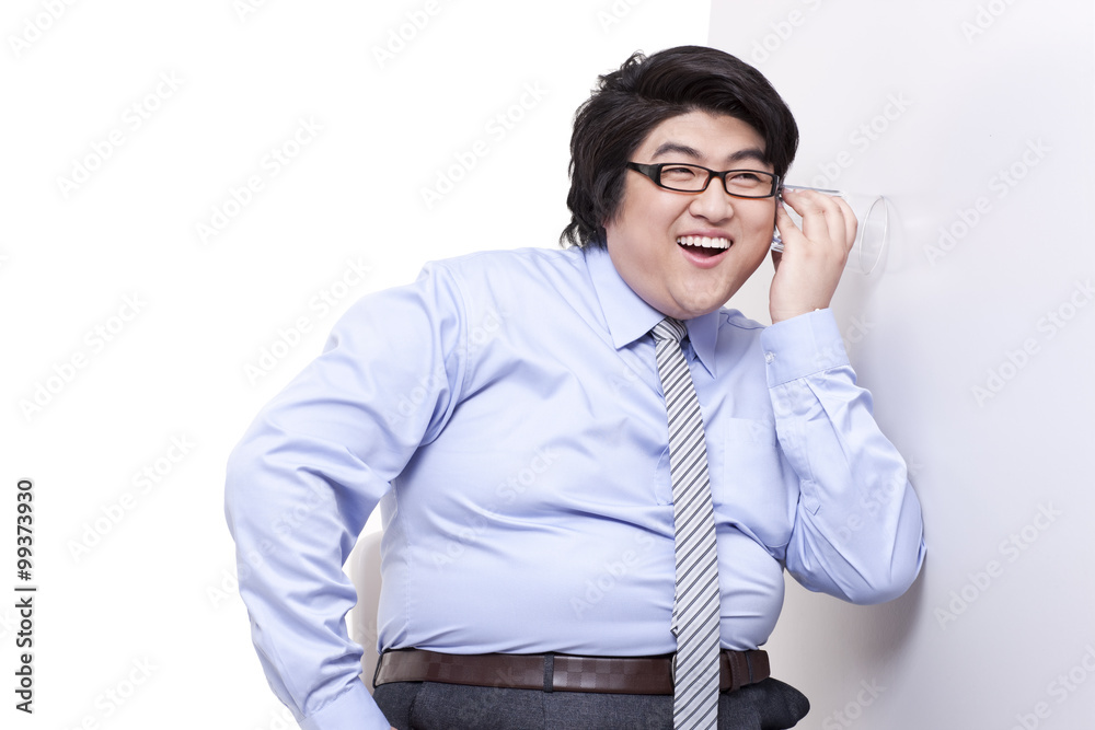 Overweight businessman doing eavesdropping