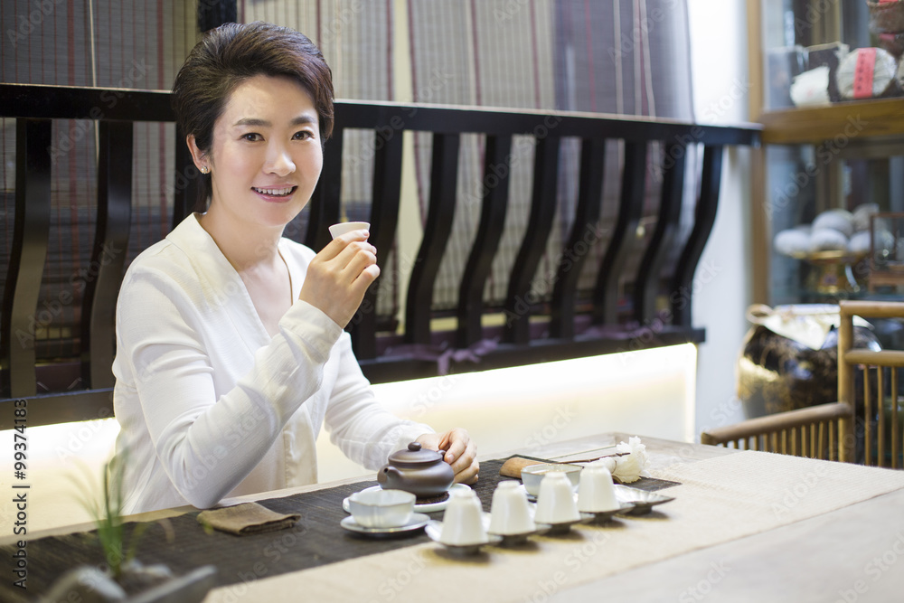 Mid adult woman performing tea ceremony