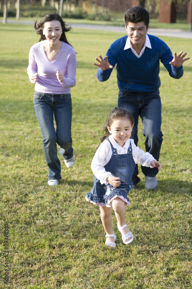 Young family playing in the park