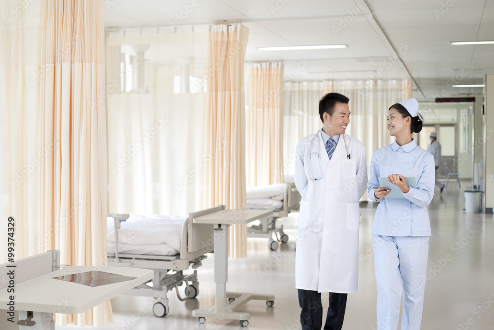 Doctor and nurse talking and walking together