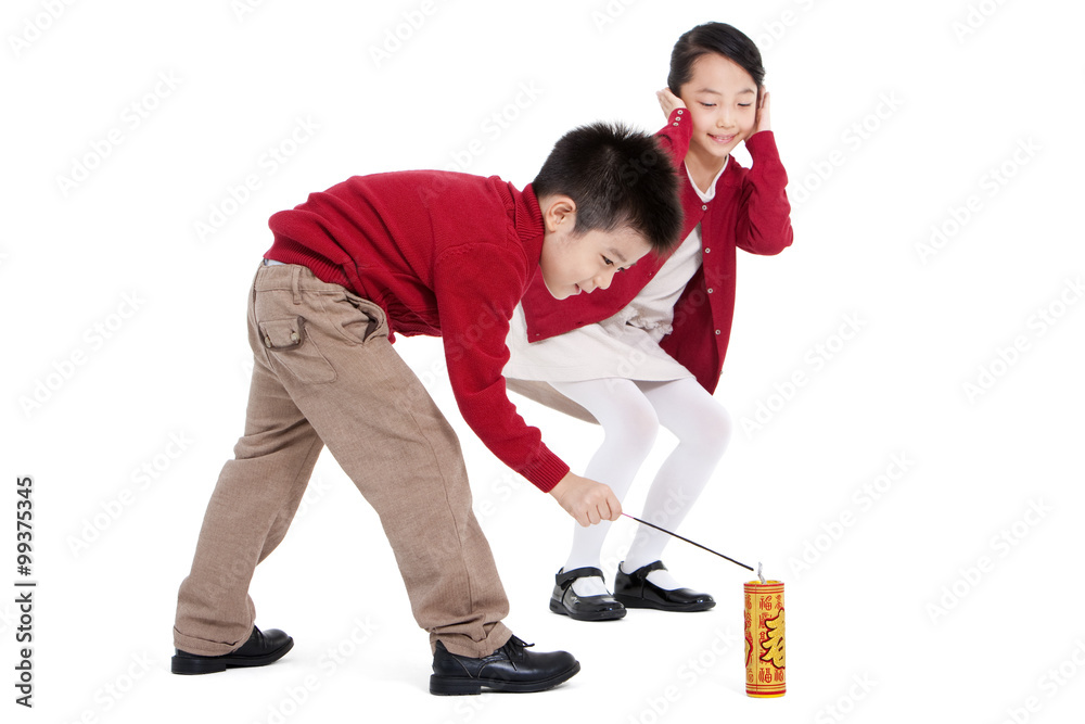 Little boy and little girl igniting firecracker together