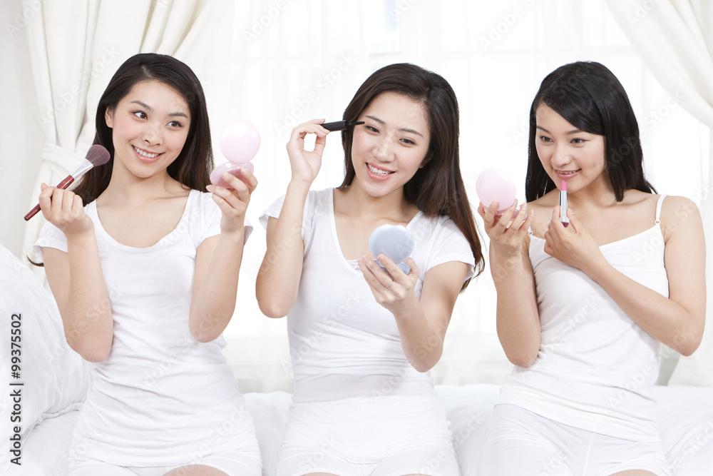 Best female friends applying make-up at home