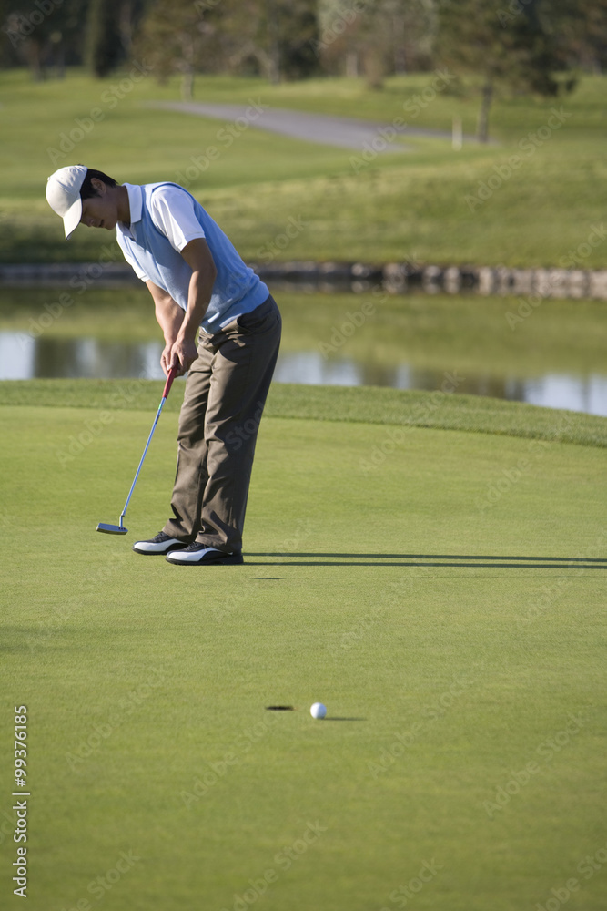 Golfer putting on the Green