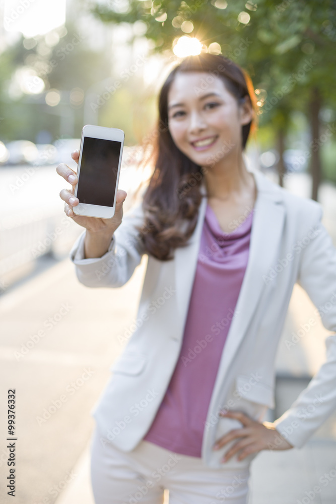 Young woman showing smart phone