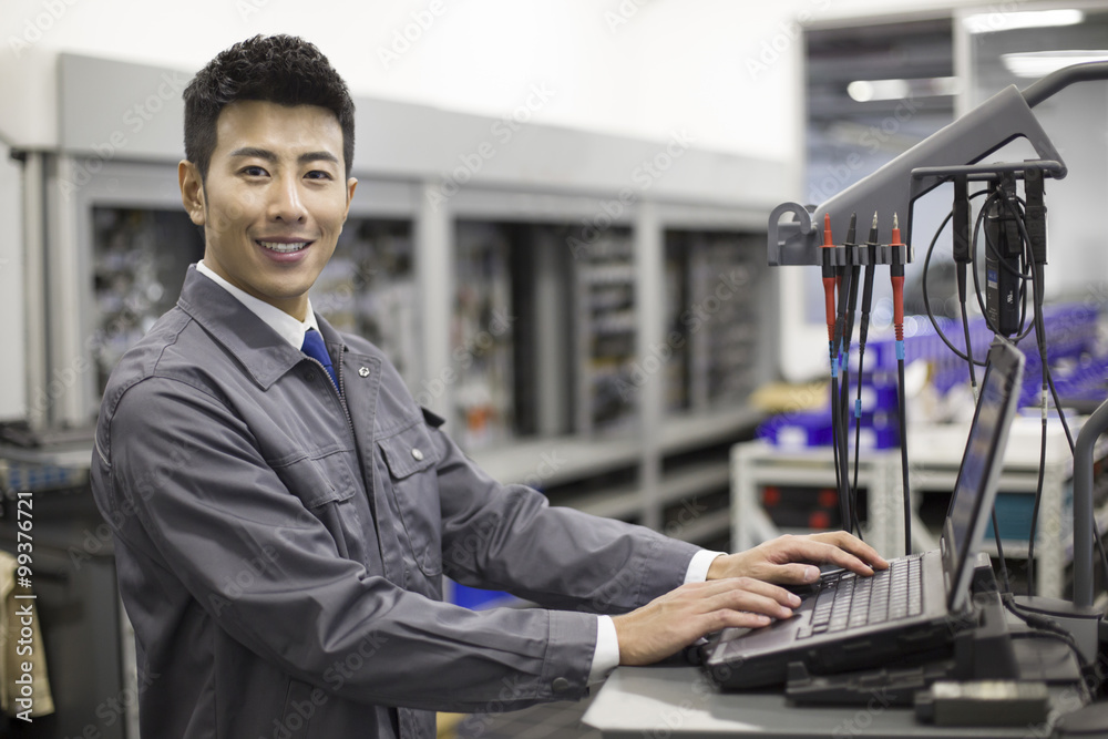 Auto mechanic working with computer