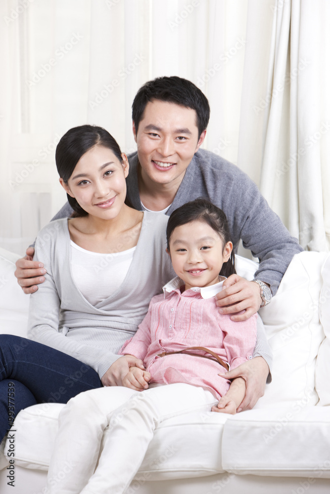 Young family sitting in couch