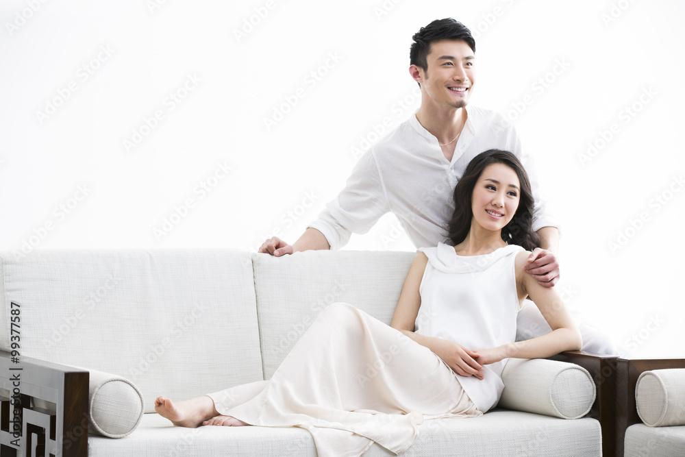 Happy young couple relaxing at home