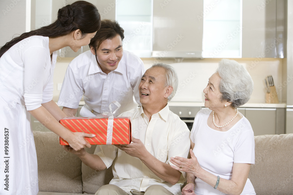 Senior man receives a gift from his family