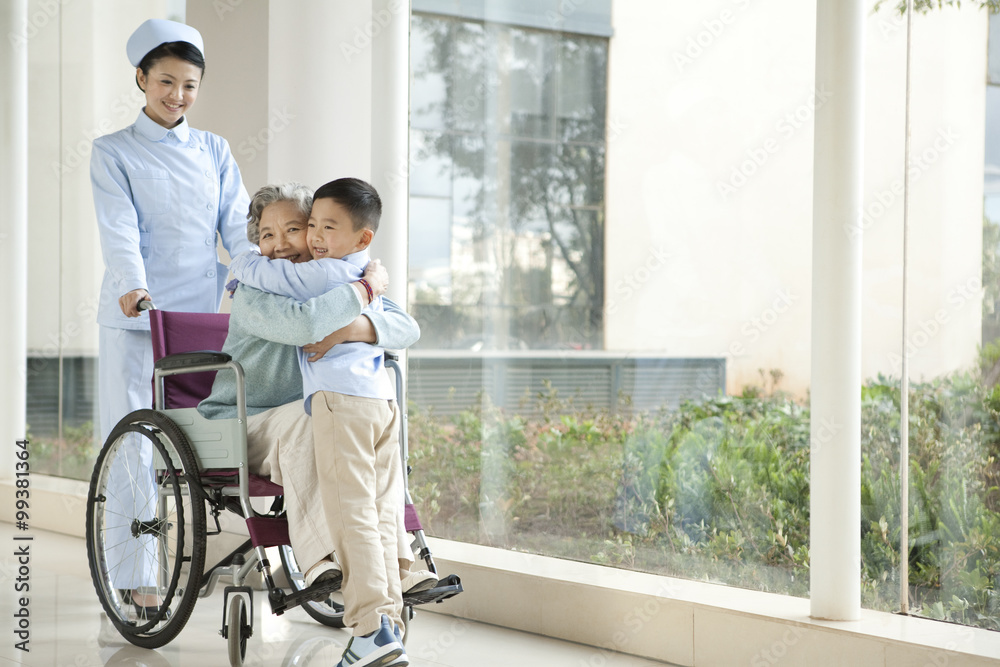 Grandson Embraces Grandmother in Wheelchair