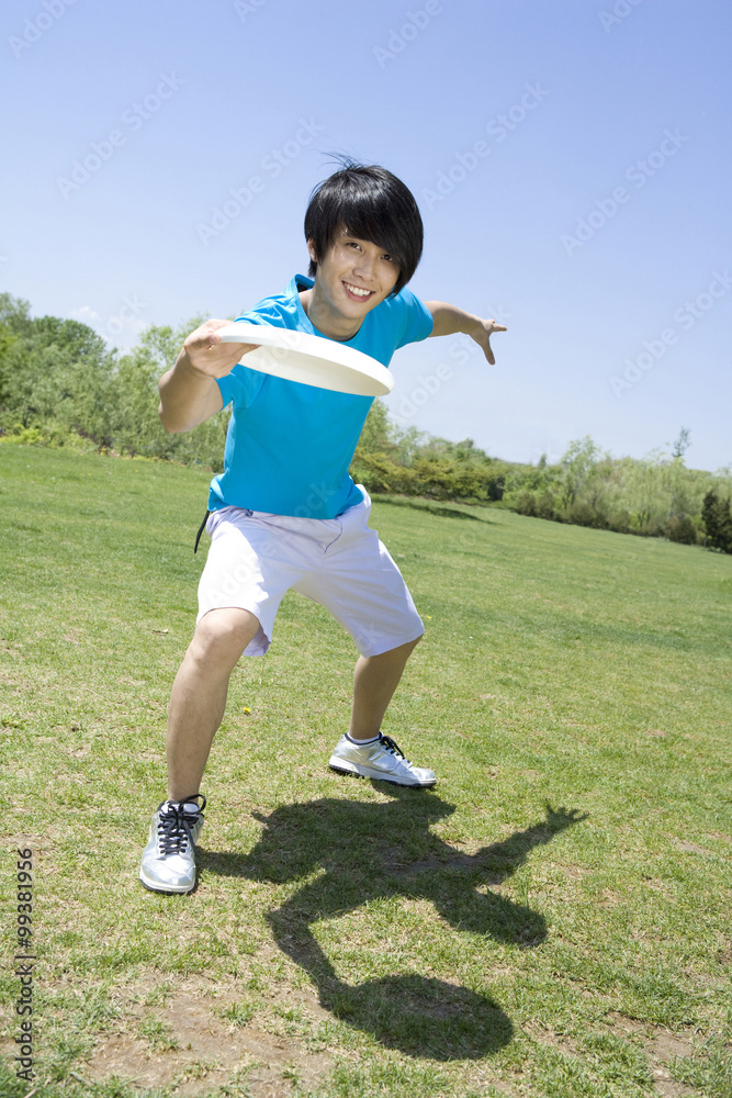 Young man throwing a Frisbee