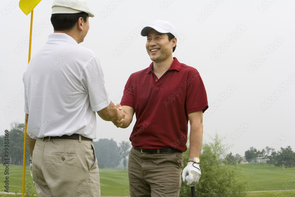 Two Golfers shaking hands on the course