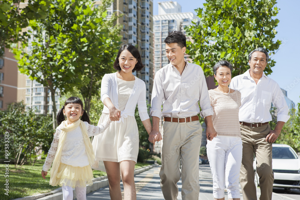 Happy family walking on street hand in hand