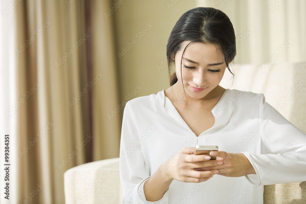 Young woman using smart phone at home