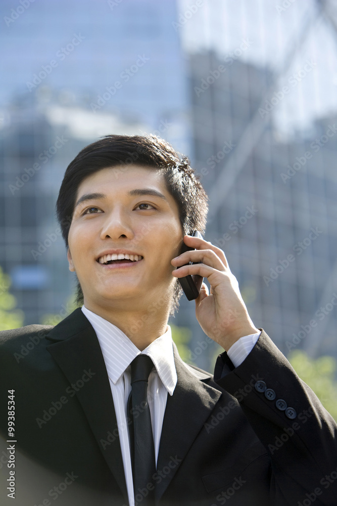 Young businessman using cellphone