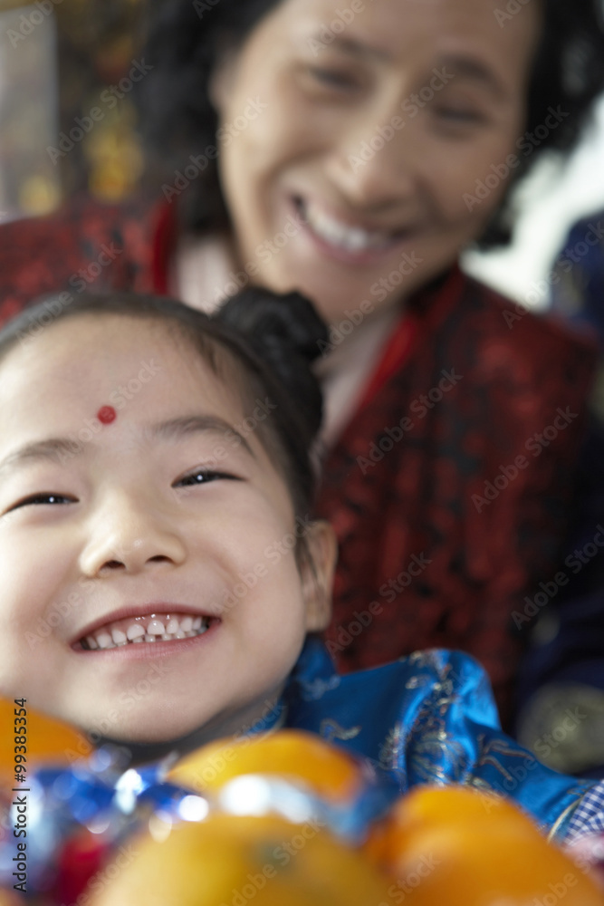 Traditionally Dressed Girl And Mature Woman Smiling