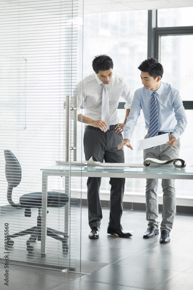 Young businessmen talking in office